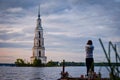 Tourist girl picturing the flooded bell tower in Kalyazin